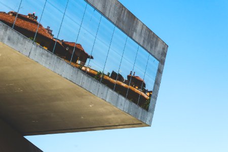 gray building with mirror glass windows at daytime