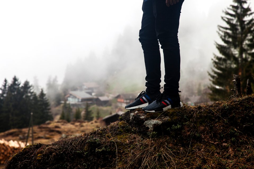 person standing on rock outdoor during daytime photo