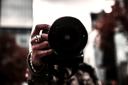 selective focus photo of person holding camera photo