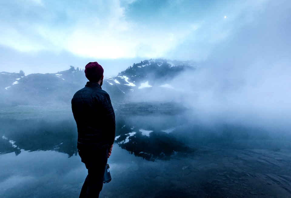 man standing near body of water