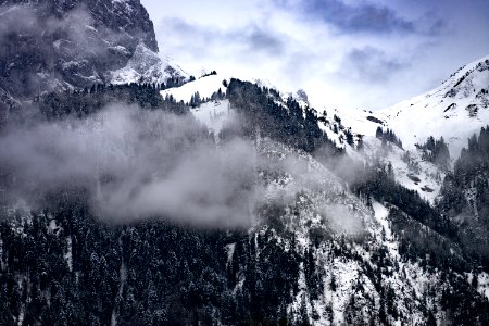 mountains with white snow and fog during daytime photo