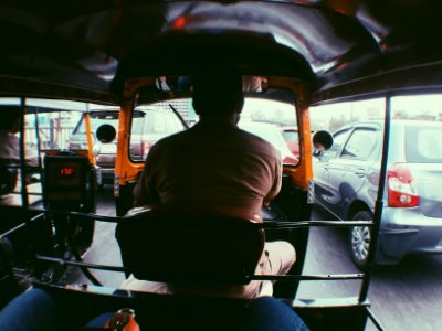 man in brown shirt driving car during daytime