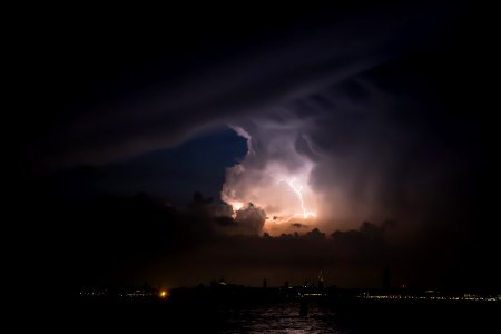 lightning above city at nighttime photo