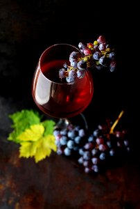 red grapes on clear glass wine photo