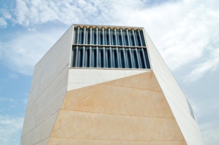 white concrete tall building under cloudy sky photo