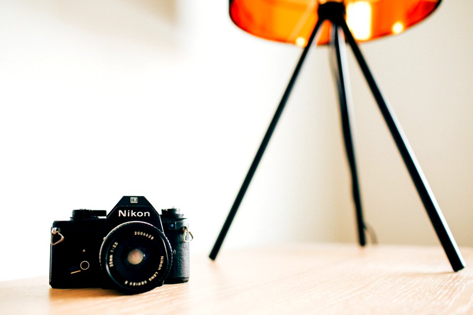 closeup photo of Nikon camera on wooden surface