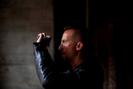 man wearing black leather jacket photo