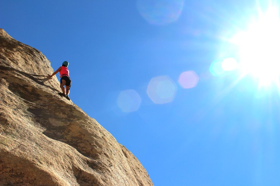 person rock climbing during day time