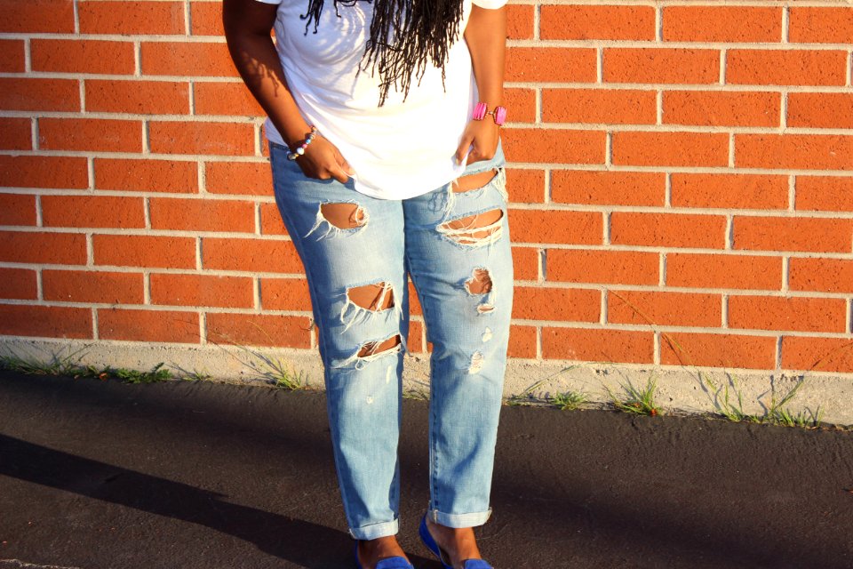 person in blue denim distressed pants