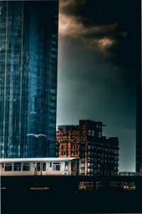gray train passing by high-rise building
