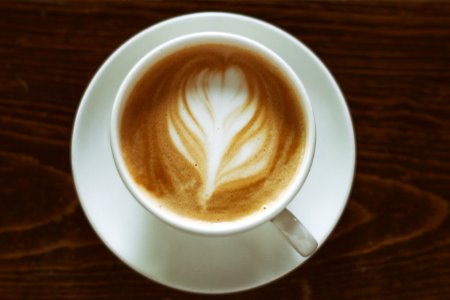 A flower shape on top of a cup of coffee. photo