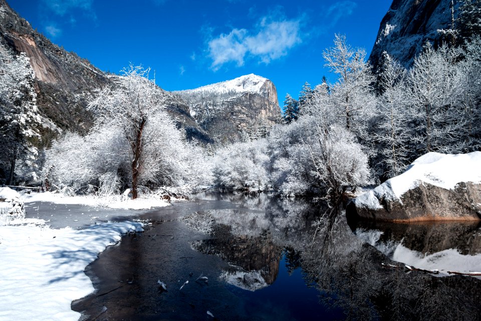 snow capped mountain near river at daytime