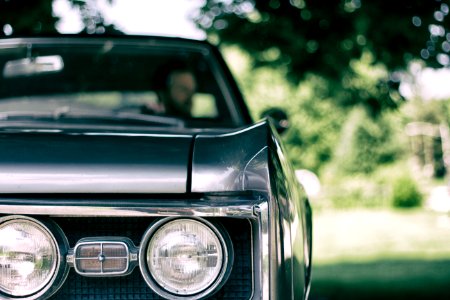 man inside black muscle car