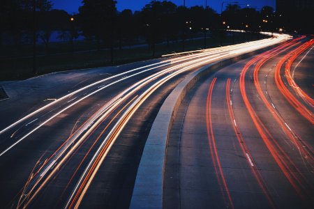 time-lapse of vehicles on road during night photo