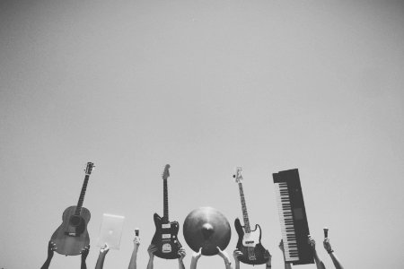 grayscale photo of people holding assorted music instruments photo