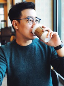 man holding Starbucks disposable cup photo