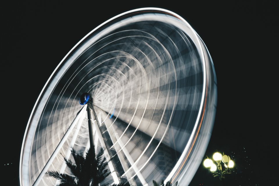 time lapse photography of ferris wheel taken during night time photo