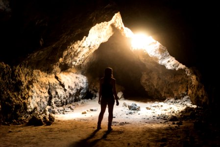 woman standing inside cave photo
