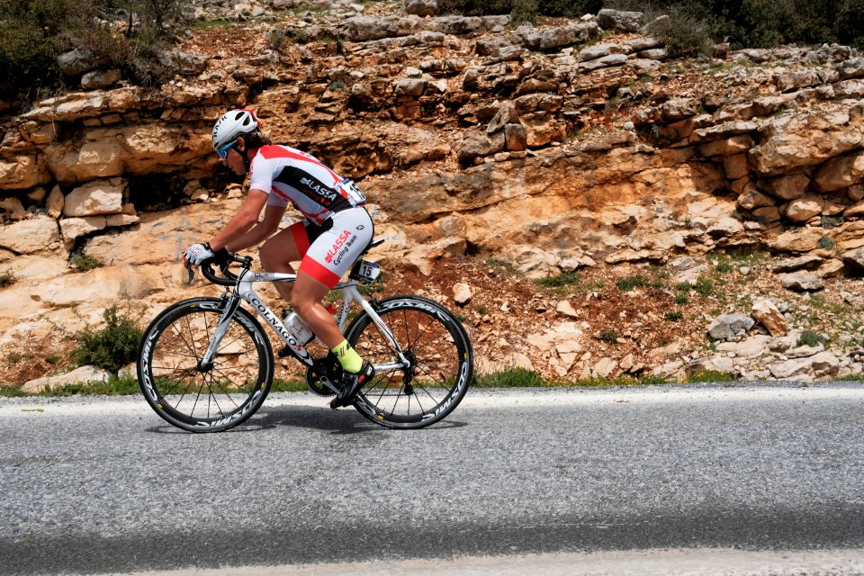 man riding road bike during day