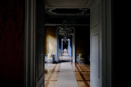 opened white wooden door near chandelier
