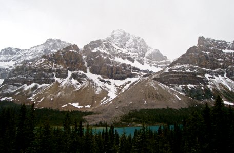 mountains covered with snow near body of water photo