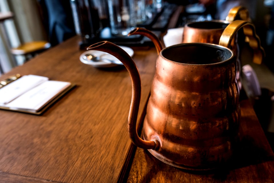tilt shift photography of vintage brass teapot