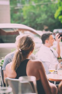 people sitting near table viewing vehicle
