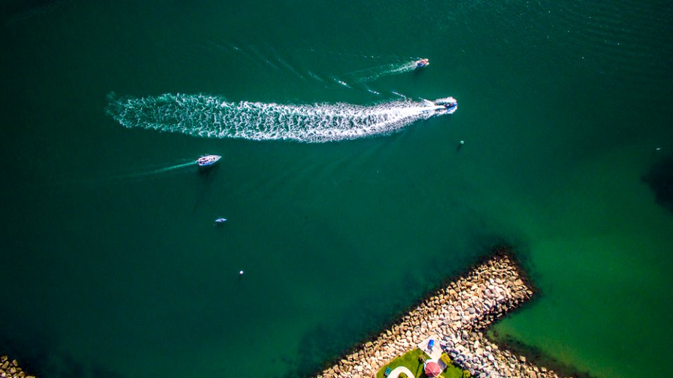 aerial view of speed boat cruising on body of water photo