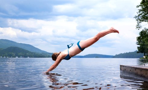 woman diving on water photo