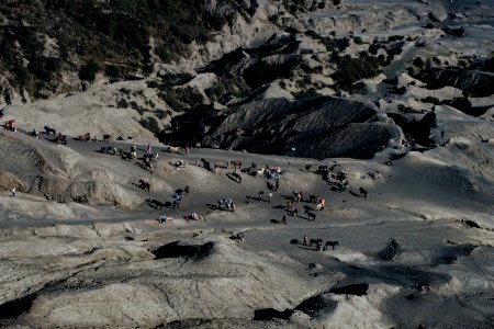 aerial photography of people standing on gray rocky mountain during daytime photo