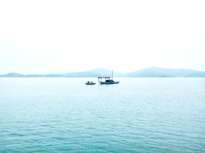 two white boats in middle of sea during daytime