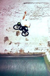 man riding black BMX bike doing bike tricks photo