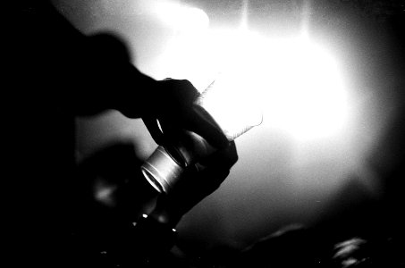 grayscale photography of person holding drinking glass