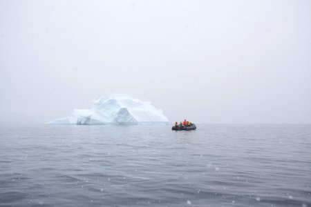 inflatable boat near iceberg photo
