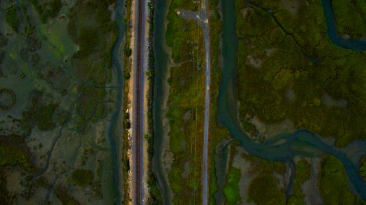 aerial photography of green field and body of water