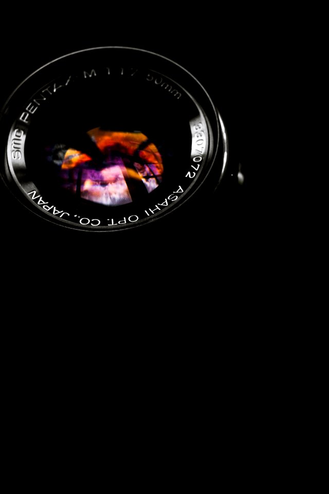 black telephoto lens on black surface