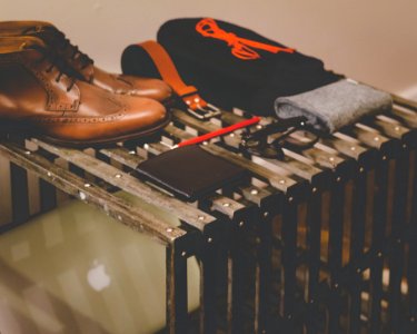 pair of brown leather dress shoes beside black leather wallet photo