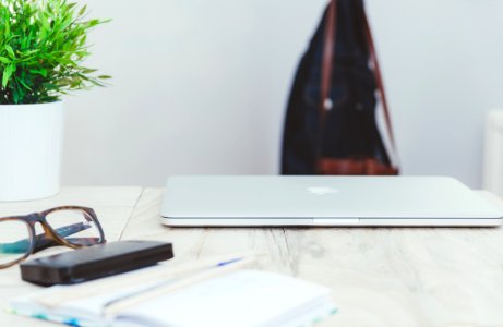 Coat hanger with a denim jacket, A leather bag, Home workstation photo