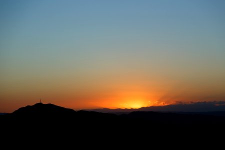 silhouette of mountain against sunrise photo