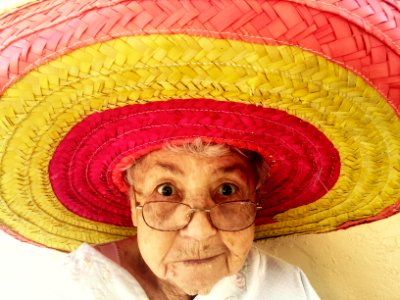 woman using eyeglasses and wearing hat