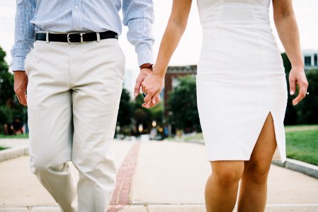 man and woman holding hands photo