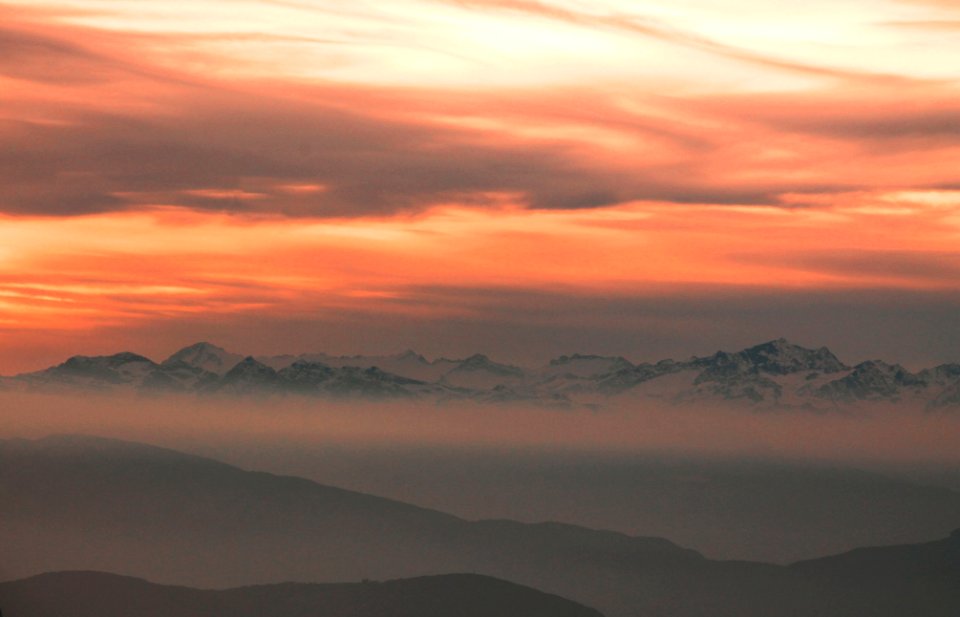 silhouette of mountains over cloudy sky during sunset photo