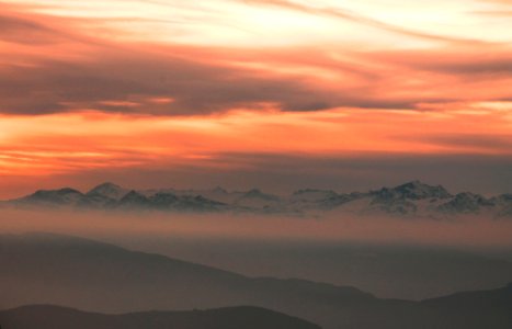 silhouette of mountains over cloudy sky during sunset photo