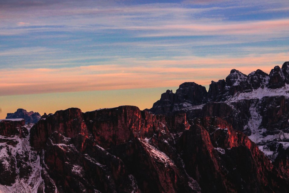 brown rocky mountain under blue cloudy sky photo