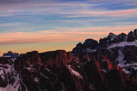 brown rocky mountain under blue cloudy sky photo photo