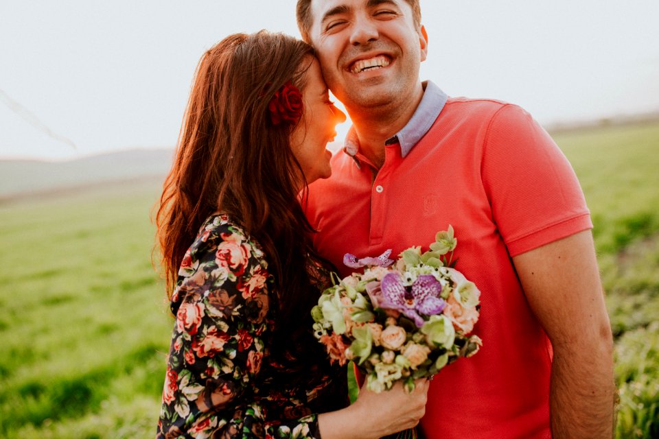 smiling woman hugging smiling man during daytime photo