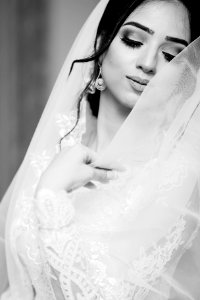 woman in white wedding dress closing eyes photo