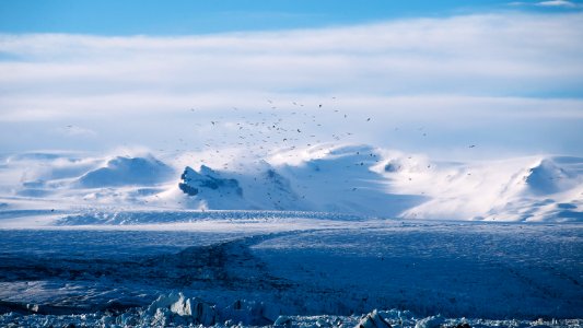 clear blue beside mountain covered with snow