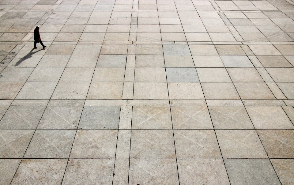 man walking on tiled ground at daytime