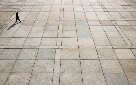 man walking on tiled ground at daytime photo